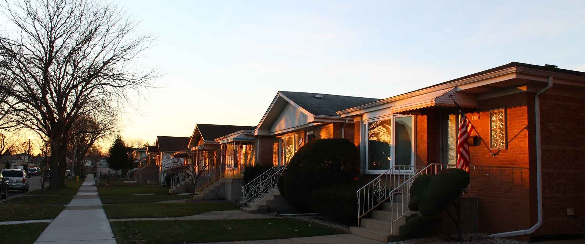 row of brick homes in a typical working class neighborhood at sunset